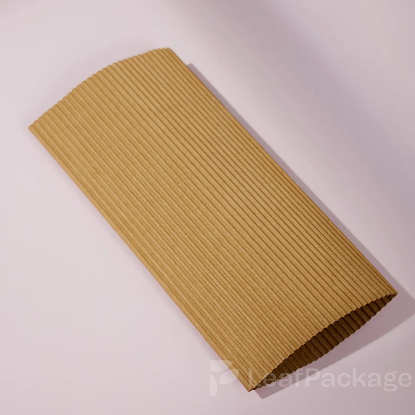 LeafPackage recyclable corrugated cushioning sleeve, eco-friendly protective packaging for glassware, bottles, and fragile products.