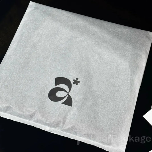 Recyclable garment bags made from lightweight tissue paper, available in bulk for small businesses.