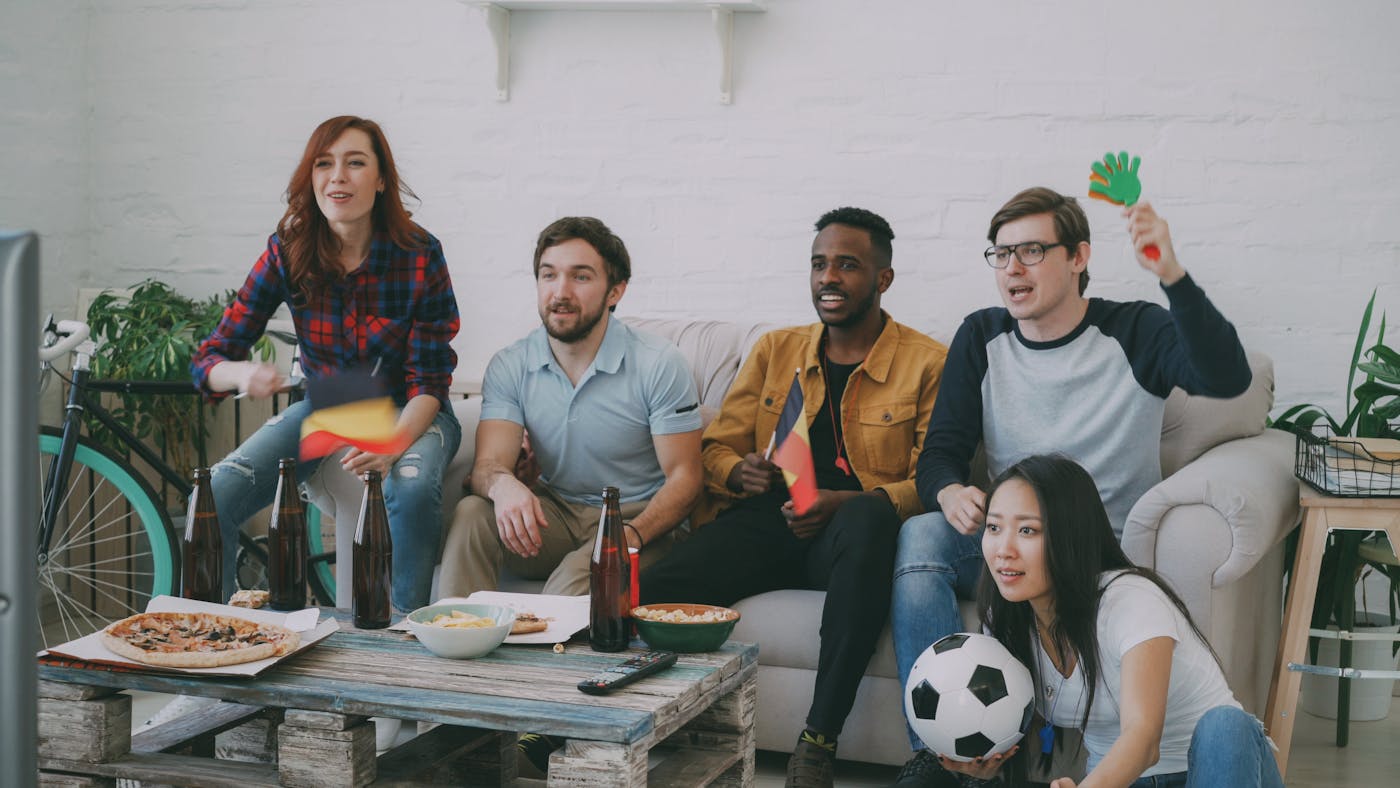 Friends watching a soccer match with snacks and drinks for packaging campaign inspiration