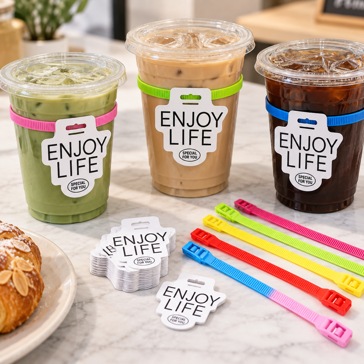 Clear PET iced coffee cups with colorful ties and custom ENJOY LIFE tags